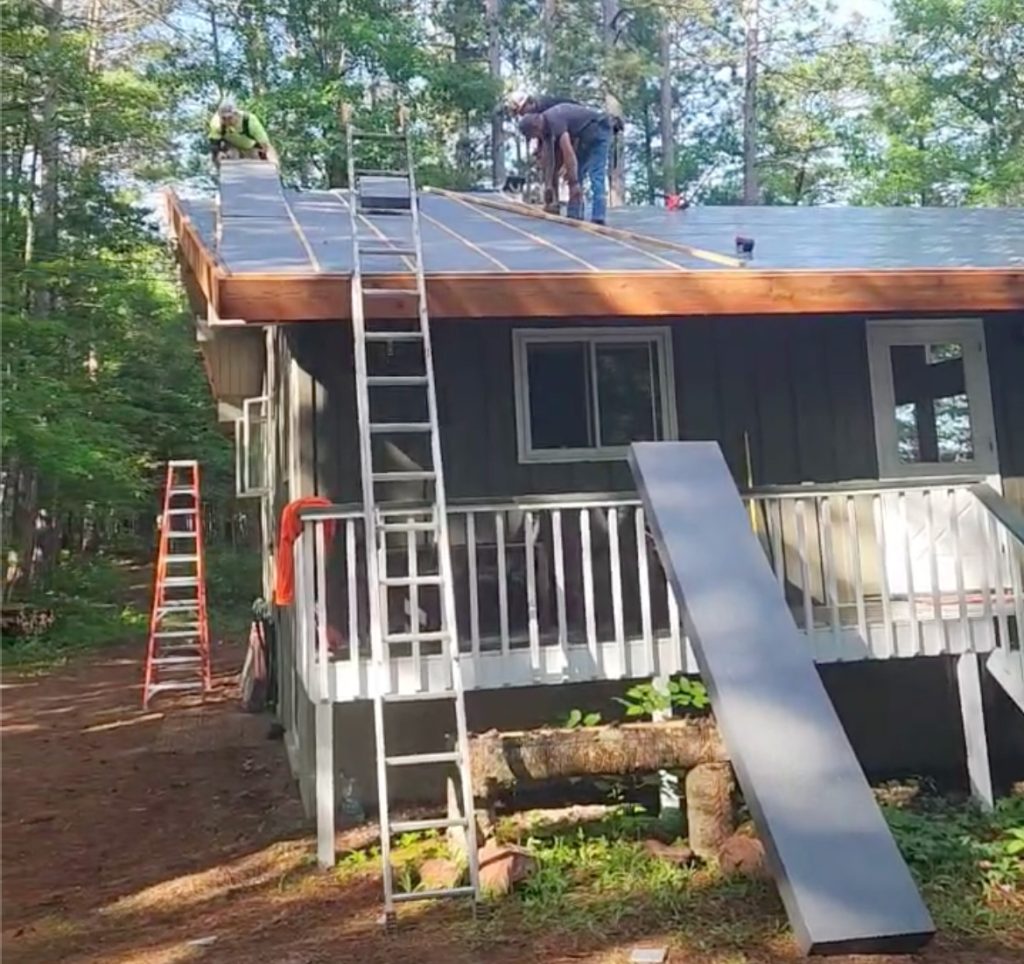 Chrome GPS insulation being installed on a Wisconsin cabin roof retrofit. Custom-manufactured panels fit precisely between the new framing, helping the crew work faster while reducing cutting, waste, and thermal bridging.